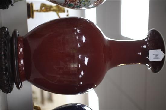 A large Chinese sang de boeuf glazed baluster vase, early 20th century, 50.5cm, wood stand, base drilled